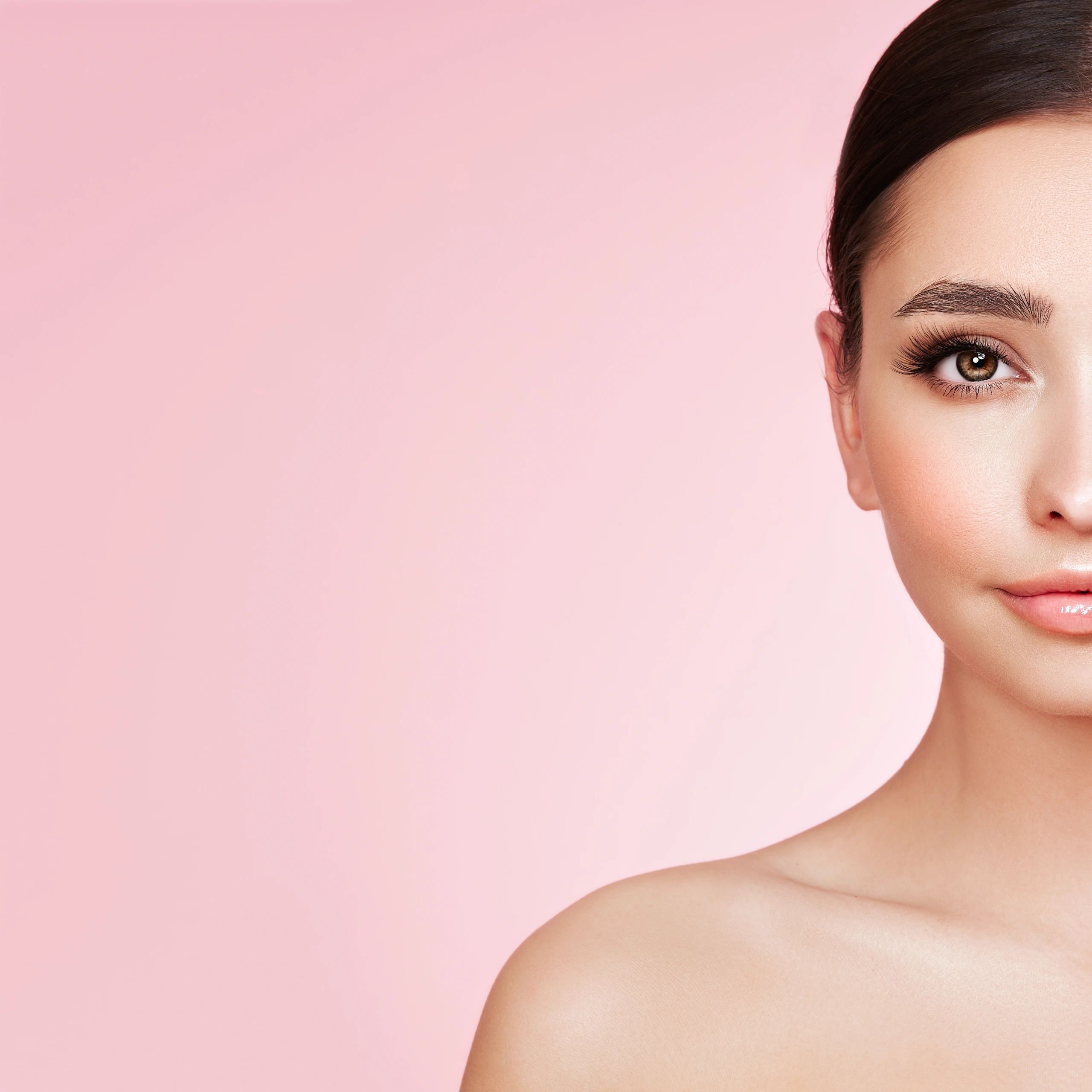 Close-up portrait of woman with healthy glowing skin
