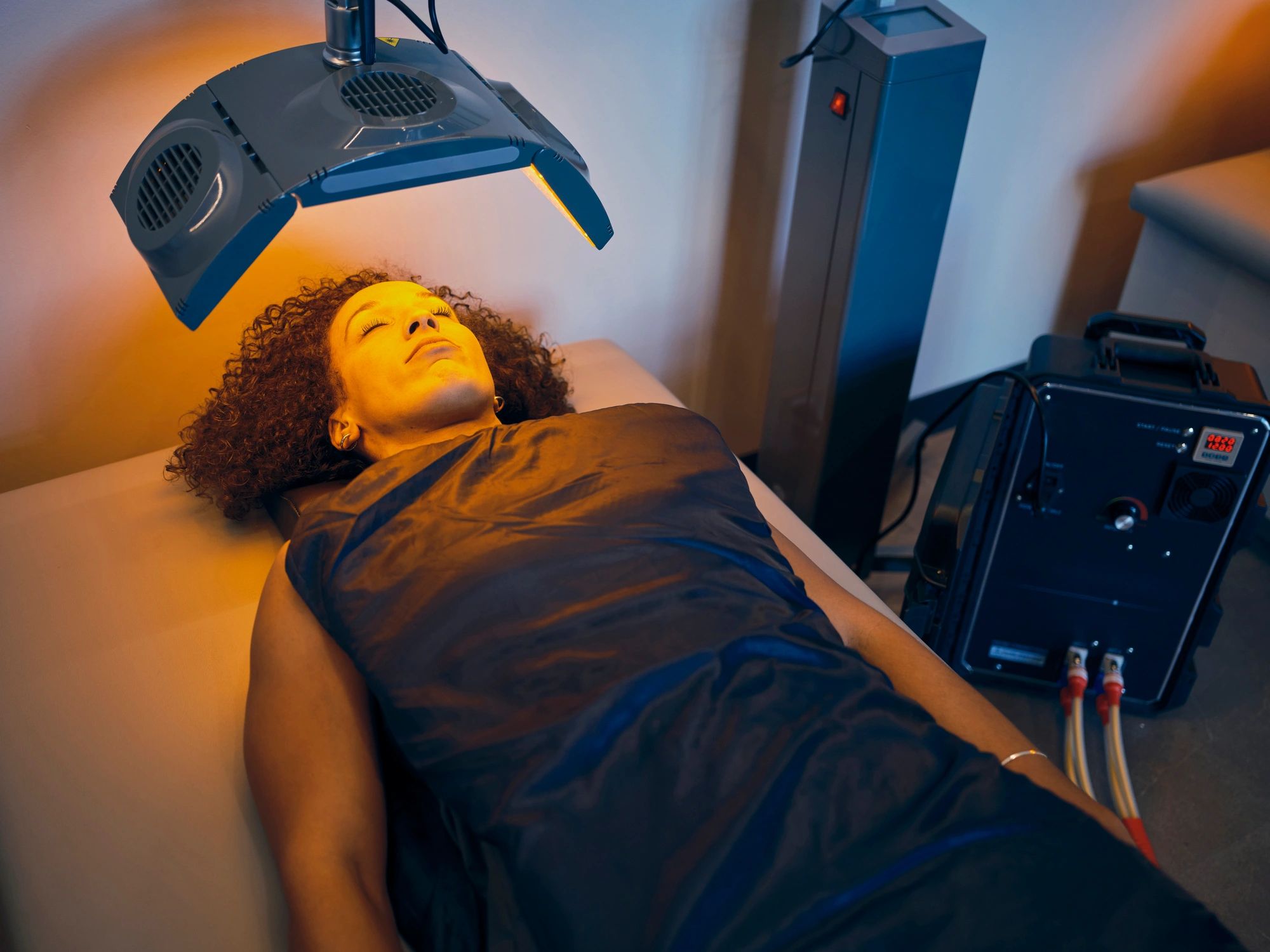 Client receiving a professional light-based facial treatment in a modern clinic