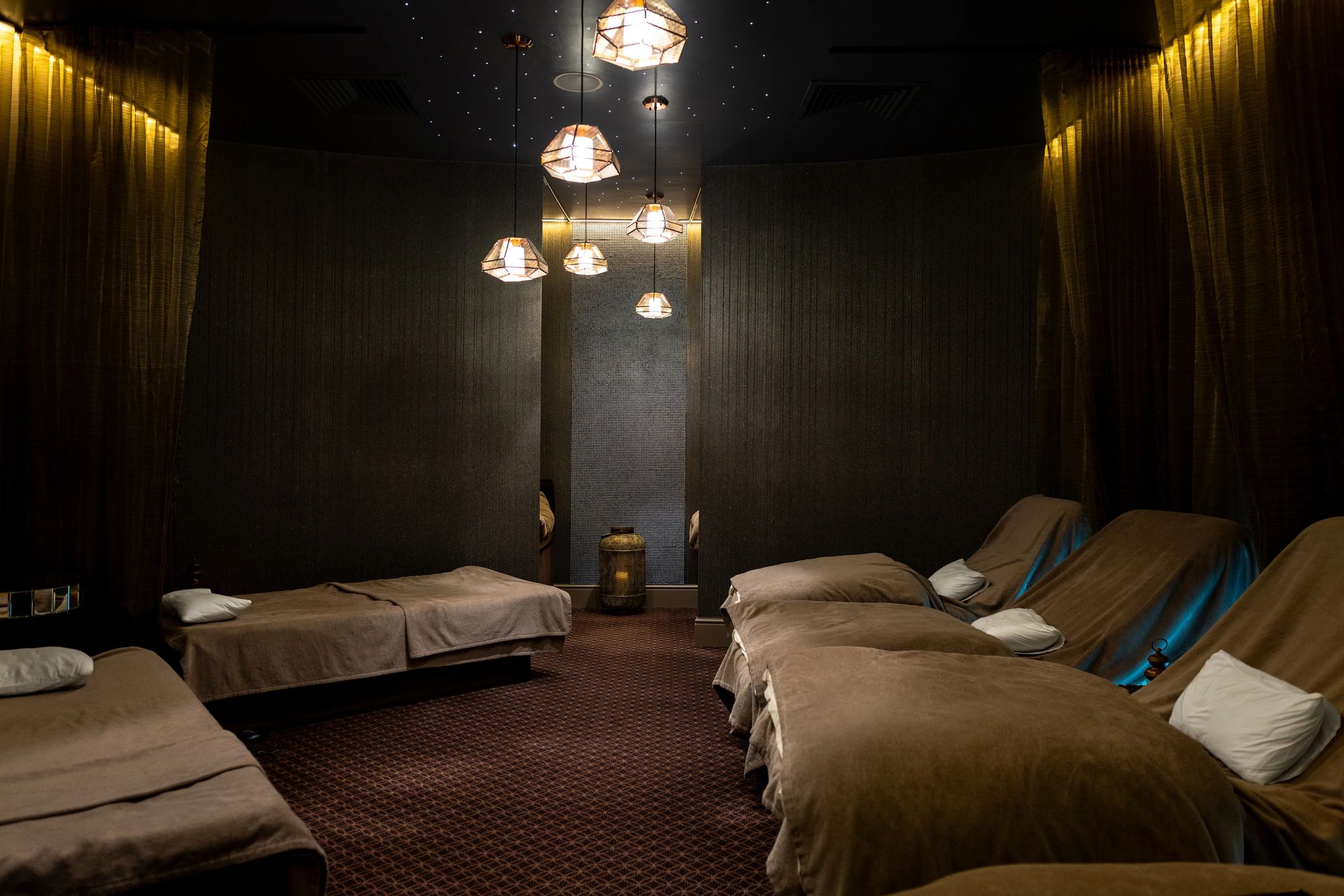 Calm spa treatment room with relaxation beds