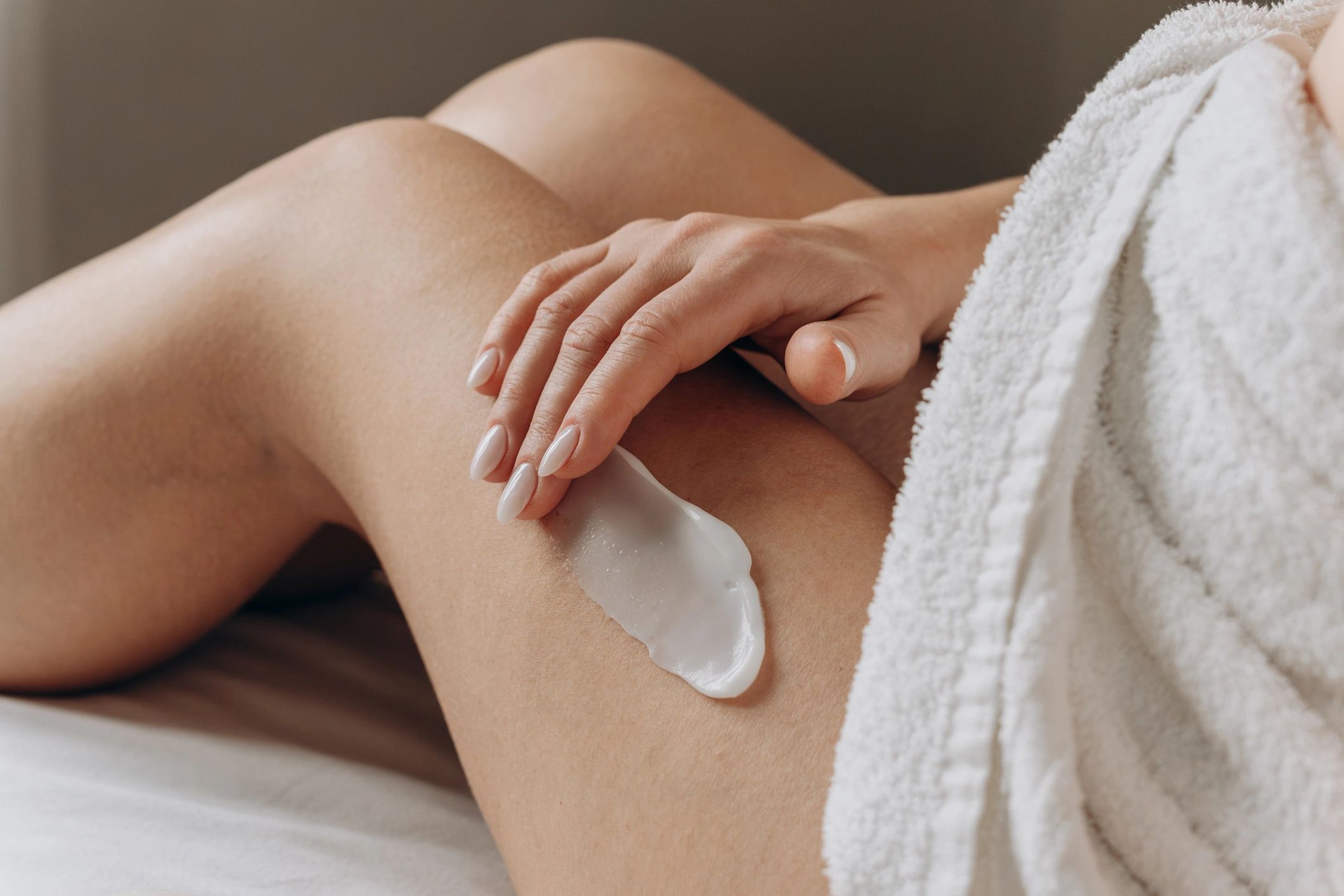 Close-up of hands applying skincare cream
