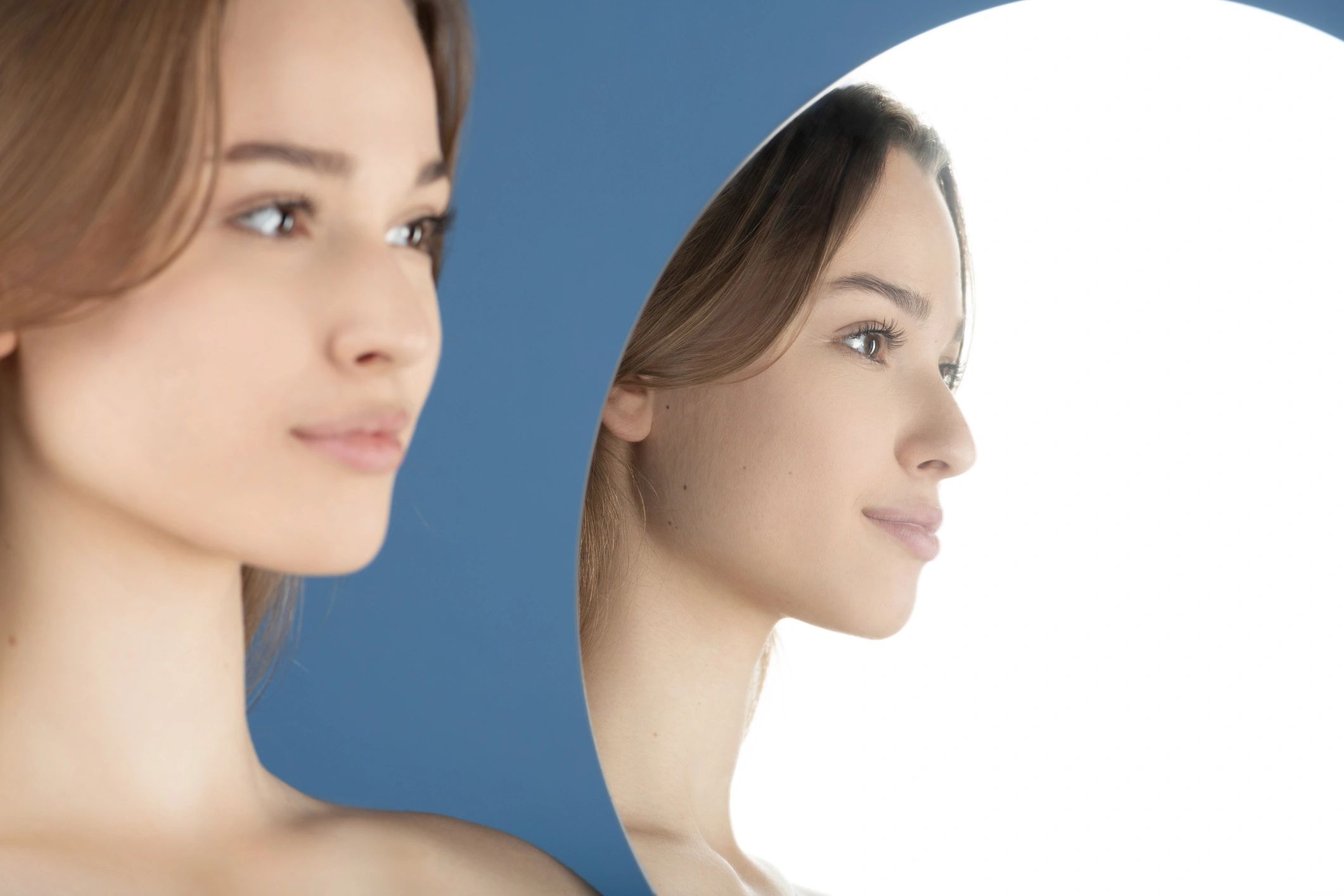 Woman looking at reflection in mirror